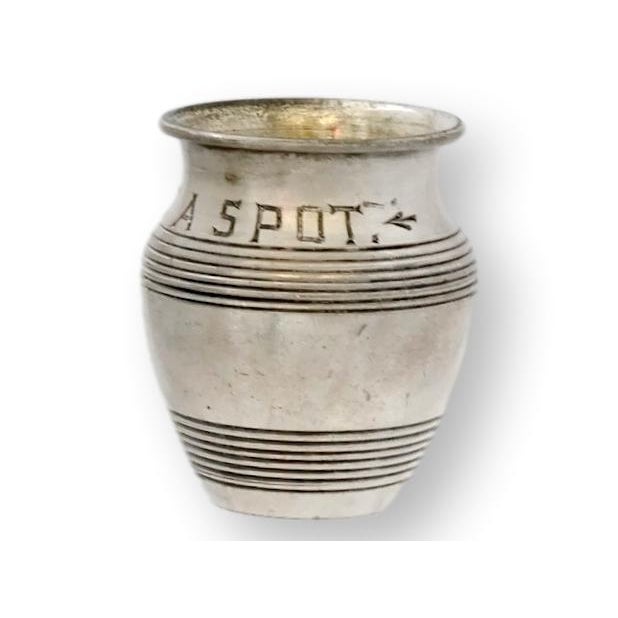 Early 20th century English silver-plate mustard pot engraved 'Just a Spot'. Featuring a ribbed barrel form and soft, time-...