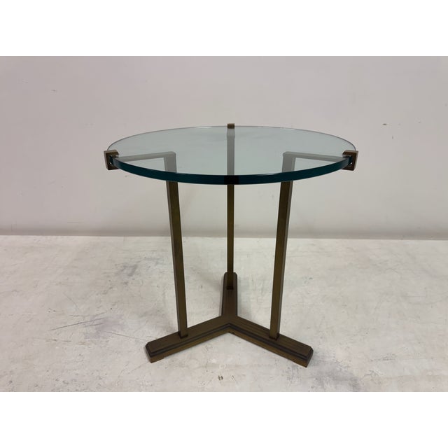 A refined late 20th Century side table by Peter Ghyczy combining a sculptural metal base with a floating glass top. The...