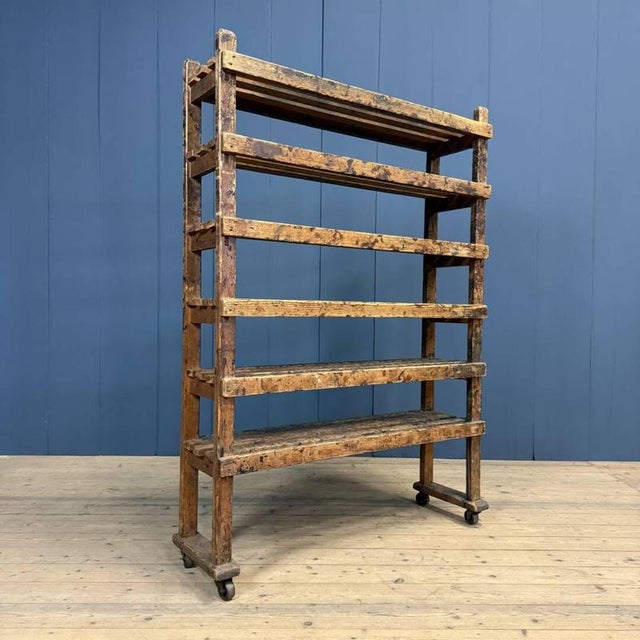 Old wooden rack originating from a shoemaker's workshop in Nijmegen, circa 1920. The wooden rack is mobile thanks to the...