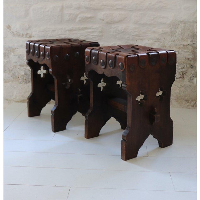 Pair of solid wood stools, Brutalist design, 20th-century French craftsmanship. The seats are upholstered in braided...