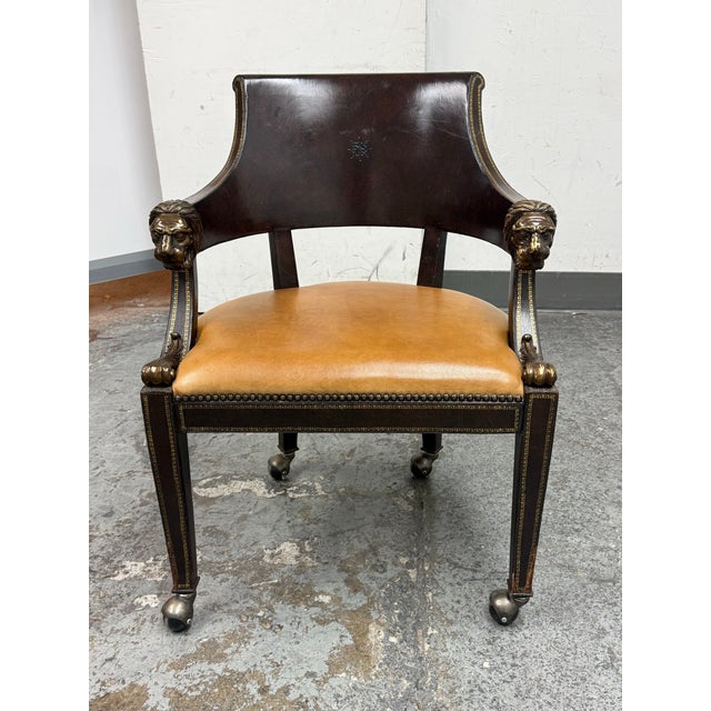 Design Plus Gallery presents a Neoclassical Lion Head Armchair from Maitland Smith. This armchair has a dark brown wooden...