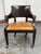 Design Plus Gallery presents a Neoclassical Lion Head Armchair from Maitland Smith. This armchair has a dark brown wooden...