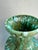 A commanding baluster-form ceramic vase glazed in a spectacular multi-layered drip finish — rich sage and emerald green...