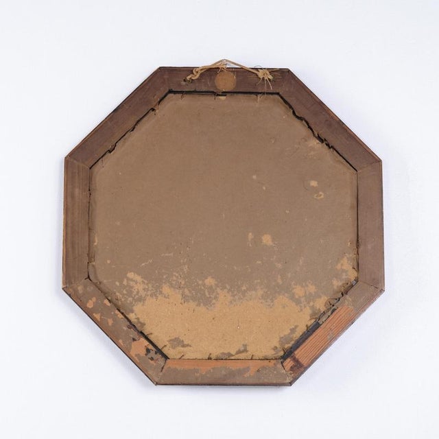 Octagonal mirror crafted in dark wood. Dating from the 1890s, it features the distinctive eight-sided shape popular during...