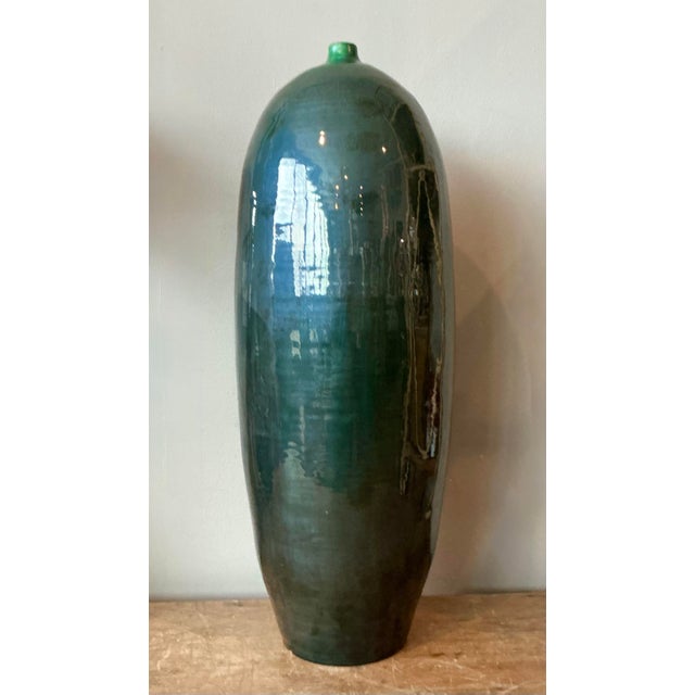 Command attention with the statuesque elegance of this monumental vintage ceramic floor vase. A striking example of mid-...