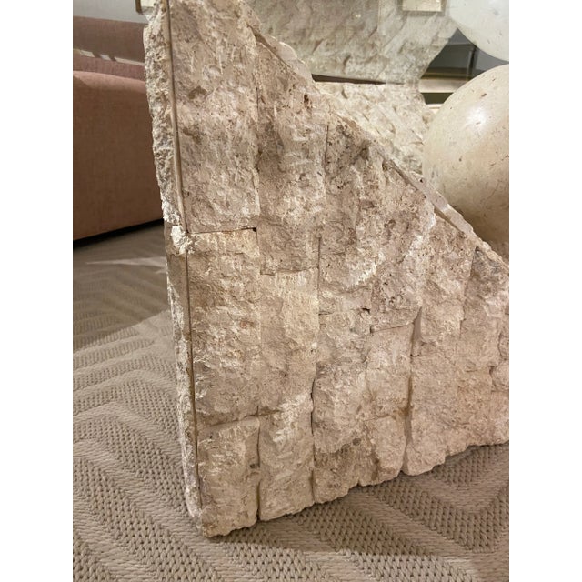 Sculpture as furniture. This piece is exactly that. A travertine sphere apearing to roll down a textured limestone wall....