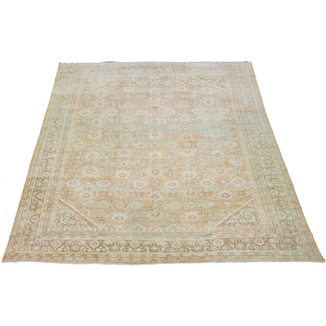 Beautiful vintage hand-knotted Mahal wool rug with an orange-peach field. It features blue, red, and ivory accents in an...