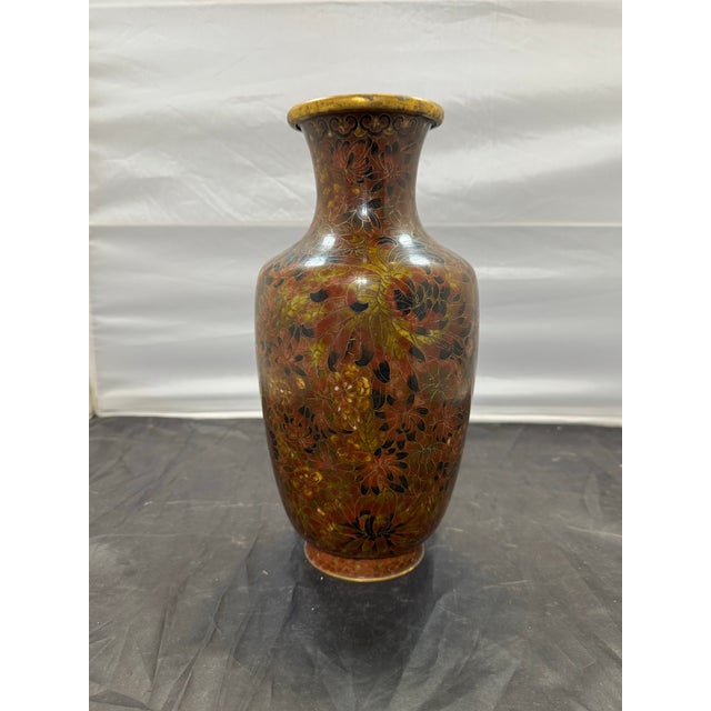 This vintage 13-inch Chinese cloisonné bottle vase from the 1950s features a beautiful floral design of peonies in red and...