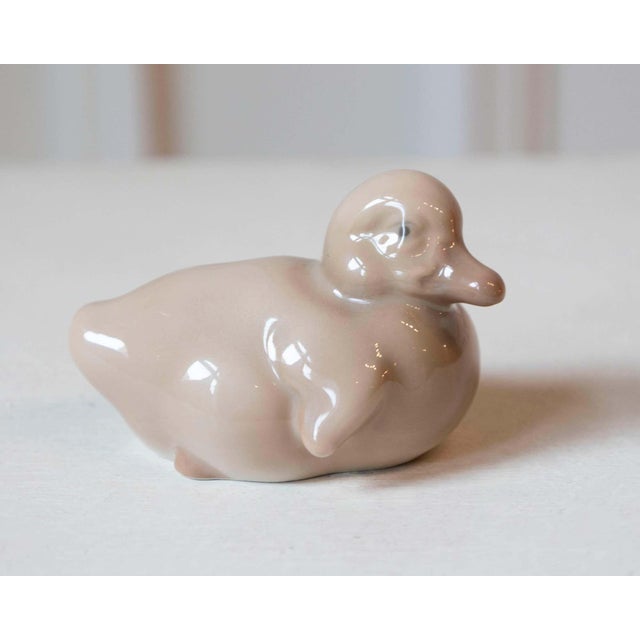 A charming porcelain duckling by Royal Copenhagen, renowned for its exceptional Danish craftsmanship and delicate...