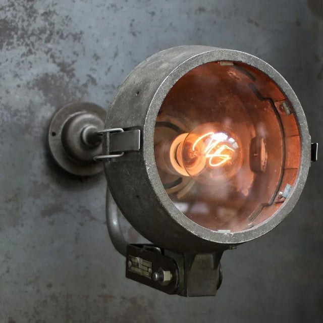 Dutch industrial wall light by Philips, Holland Cast aluminium, cast iron and clear glass Diameter wall piece 10.5 cm / 4”...