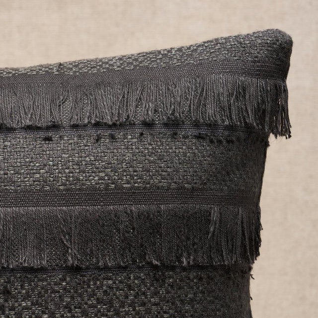 This pillow features Acadia with a knife edge finish. A horizontal fringed stripe, this pattern derives from a textile in...