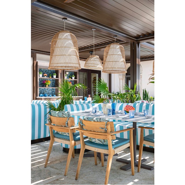 A woven rattan pendant light from Oggetti's Bella collection, designed by Vito Selma and hand-woven by Philippine...