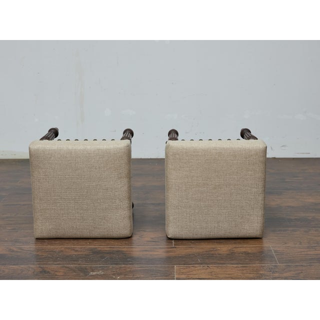 A pair of 19th-century English oak stools with custom linen upholstery. The square seats are covered in a custom neutral...