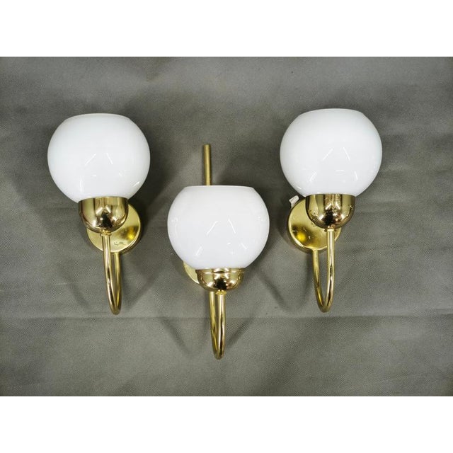 A sophisticated set of three wall lights manufactured by kamenický šenov in czechoslovakia during the 1970s. These elegant...