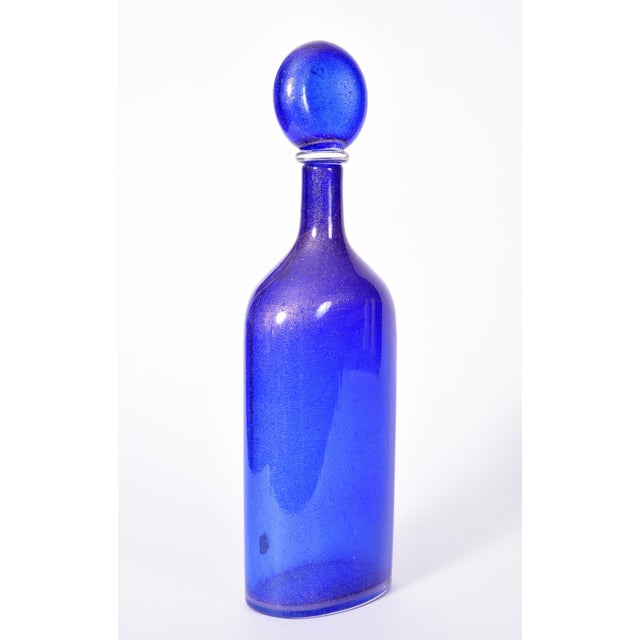 Mid-20th century cobalt blue with gold fleck Murano glass decanter. The decanter is in excellent condition, maker's mark...