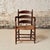 This 19th Century French Provincial oak chair features a beautifully worn rush seat, gracefully curved ladder back, and...