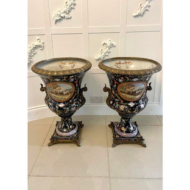 A magnificent pair of large antique French porcelain jardinière urns dating to circa 1880, lavishly decorated with hand-...