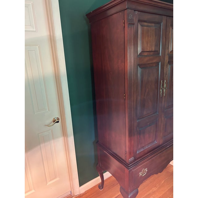 Bring timeless American craftsmanship into your space with this stunning vintage highboy wardrobe armoire by the renowned...