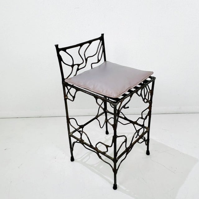 Unique wrought iron vanity stool in the style of Les Atelier Courbet. Heavy and sturdy with iron slats supporting leather...