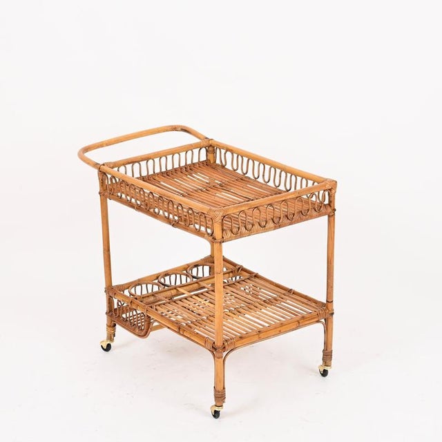 Wonderful and unique Italian serving cart entirely handcrafted in bamboo, curved rattan and hand-woven wicker. This...