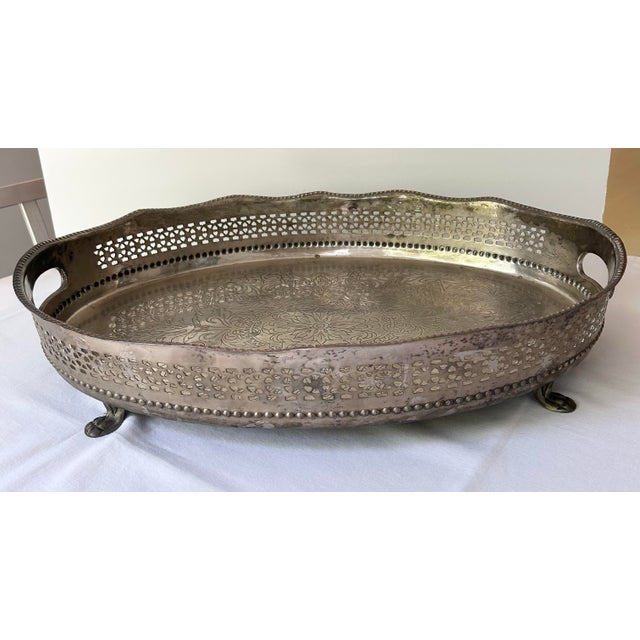 Beautiful Castilian Imports large oval serving tray with four lion feet, side handles, a scalloped edge and perforated...