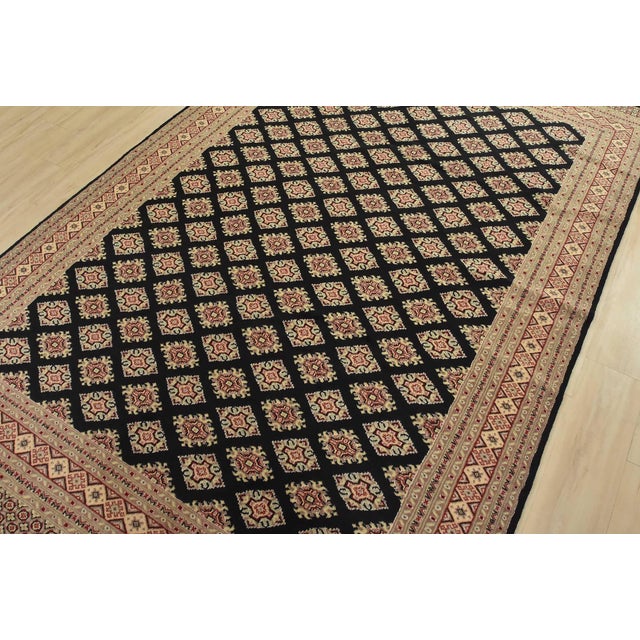 A tribal Bokhara Jaldar rug hand-knotted with fine wool on a cotton foundation. This rug features rows of repeating...