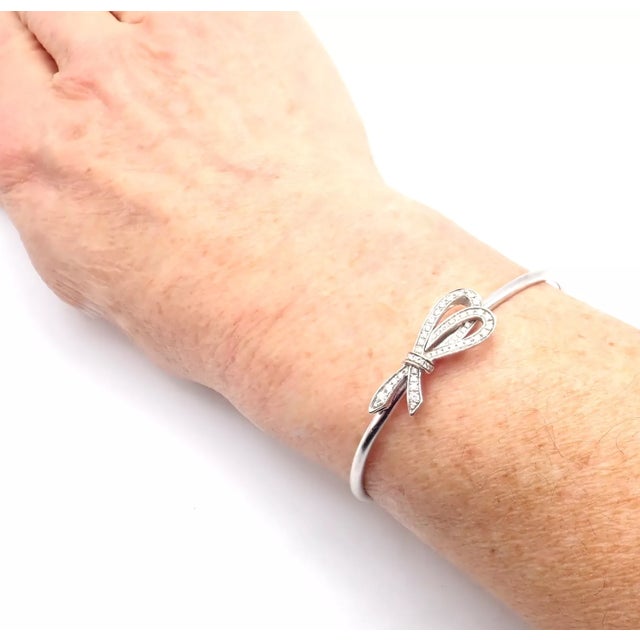 Tiffany & Co. 18k White Gold Diamond Bow Ribbon Bangle Cuff Bracelet Details: Metal: 18k White Gold Length: 6.25" Weight:...