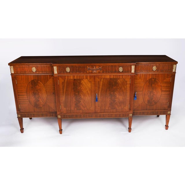 This is a elegantly proportioned regency revival, vintage flame mahogany and ormolu mounted breakfront sideboard by the...