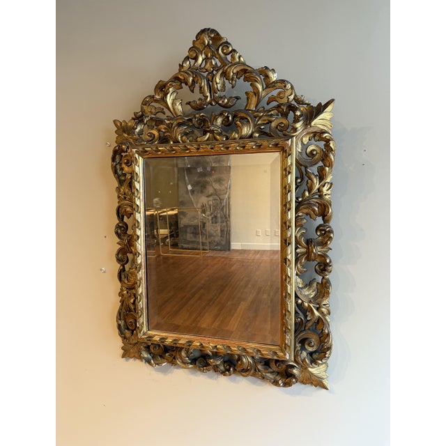 This 18th-century giltwood mirror has been exquisitely crafted with a richly gilded frame and intricate carved detailing....