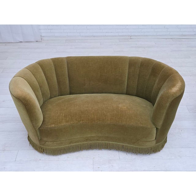 1960s, Danish 2-seater "Banana" sofa. Original green furniture velour, oak wood legs, brass springs in the seat. Original...