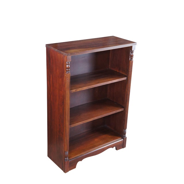 Mid-20th Century Victorian style bookcase. Features a mahogany frame with reeded columns along the front and two fixed...