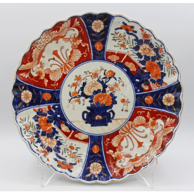 Circa 1870 Imari scalloped, molded chop plate, Japan. Four alternating design large reserves surround a central large...