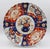 Circa 1870 Imari scalloped, molded chop plate, Japan. Four alternating design large reserves surround a central large...