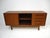 A teak wood two sliding door credenza with adjustable shelves and four drawers to the right side making for perfect...