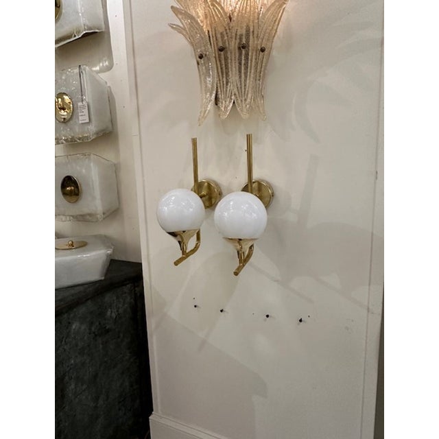 Nice pair of white Murano glass ball form sconces on a polished brass base. Simply beautiful!