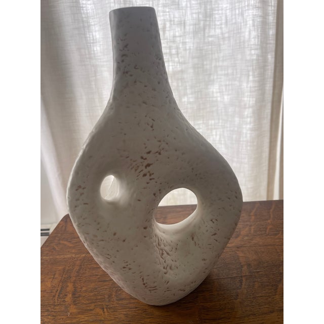 Jonathan Adler ceramic sculptural vase. This vase is in perfect condition, with a pebble texture and is off white in color.