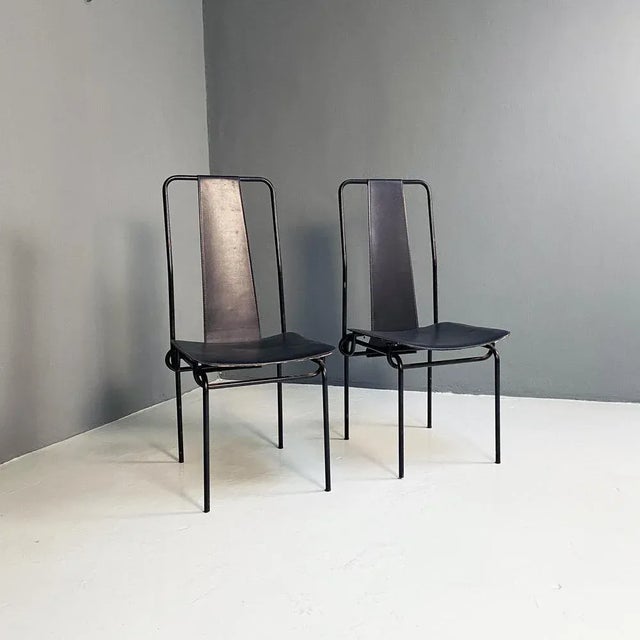 Black chairs in enamelled metal rod, with seat and high back in black leather by Adalberto del Lago for Misura Emme,...