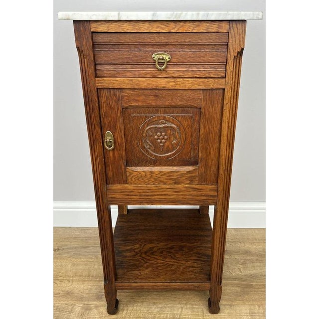 Enhance your home with this elegant Antique French bedside table , beautifully crafted in oak and topped with a striking...