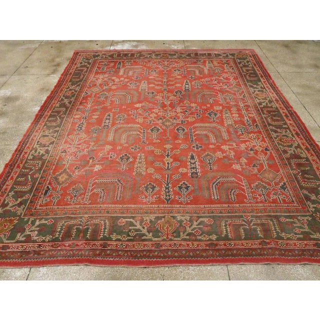 An antique Turkish Oushak room size carpet handmade during the Early 20th century. Measures: 11' 1" x 13' 6"