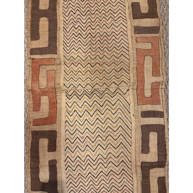 Hand-woven and embroidered/appliquéd fibers from the raffia palm (Raphia). Features a central chevron or zigzag panel...