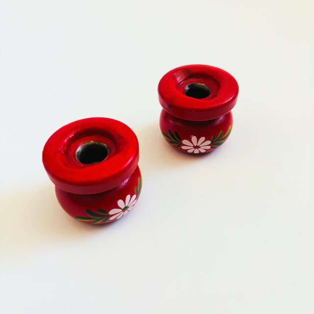 A set of 2 vintage Swedish folk art tiny taper taper candle holders. Each red in color with a lovely hand painted floral...
