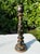 A distinctive vintage hand-painted candlestick featuring an elegant turned silhouette decorated with delicate floral...