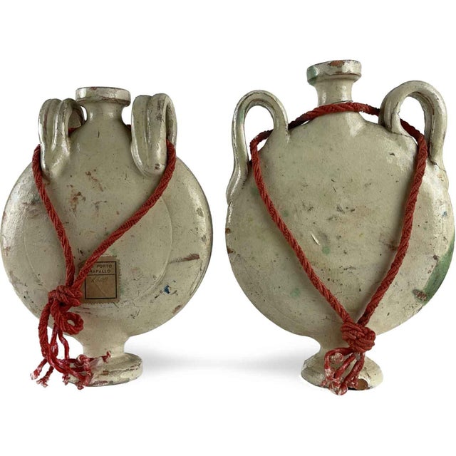 A pair of late 19th-century ceramic wayfarer's flasks, lenticular in shape, with a white background and abstract...