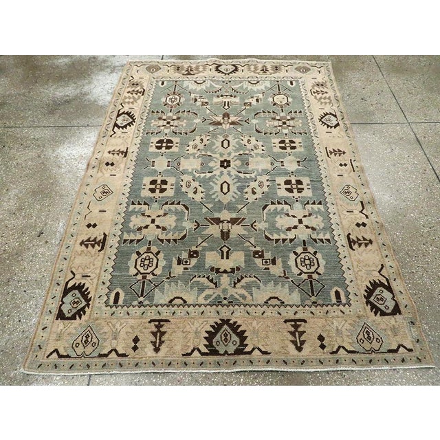 This mid-20th-century Persian Malayer accent rug presents a balanced geometric-floral composition across a muted blue...