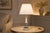 A charming and elegant vintage ceramic table lamp featuring a beautifully decorated blue and white porcelain body with...