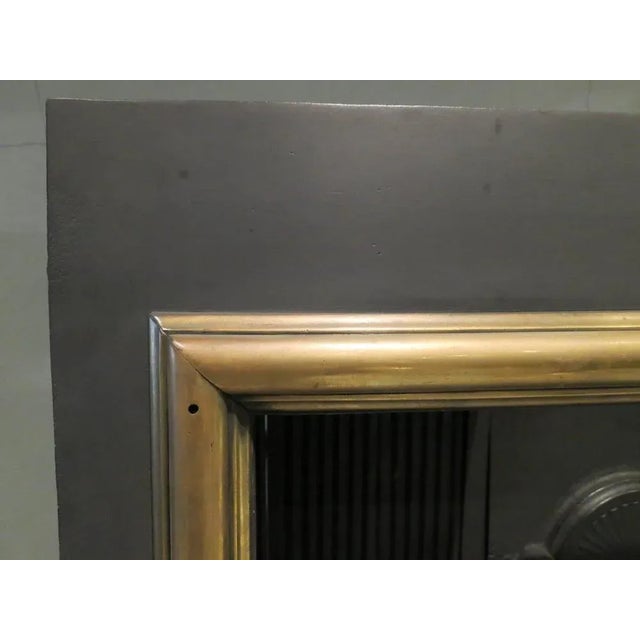 A turn of the 19th-20th century register grate, in the Georgian manner with brass boarder, reeded interior, fan decoration...