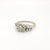 A fine Mid-Century gold & diamond engagement ring. In 14 karat white gold with a retro openwork design. Set with a round...