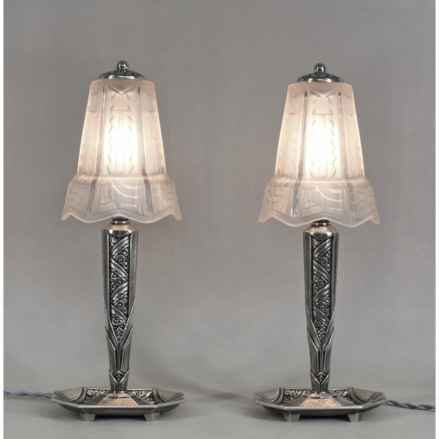 PIERRE MAYNADIER A pair of French art deco lamps by Maynadier made circa 1925-1935. The nickel-plated bronze or solid...
