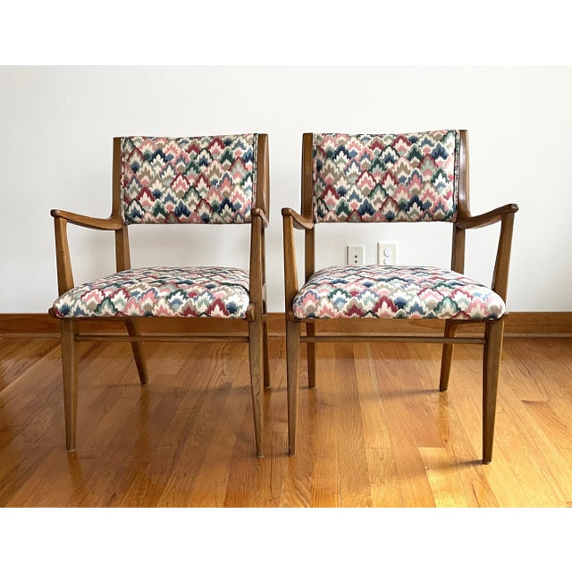 A pair of mid-century modern Drexel chairs by John Van Koert. The vintage dining chairs have been reupholstered in a flame...