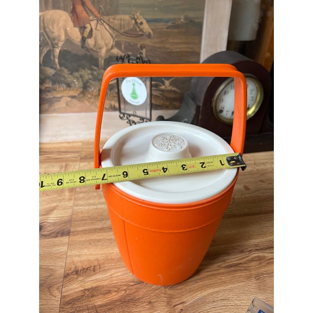 Up for consideration is a beautiful vintage orange plastic ice bucket with a white lid. This would look lovely in your...